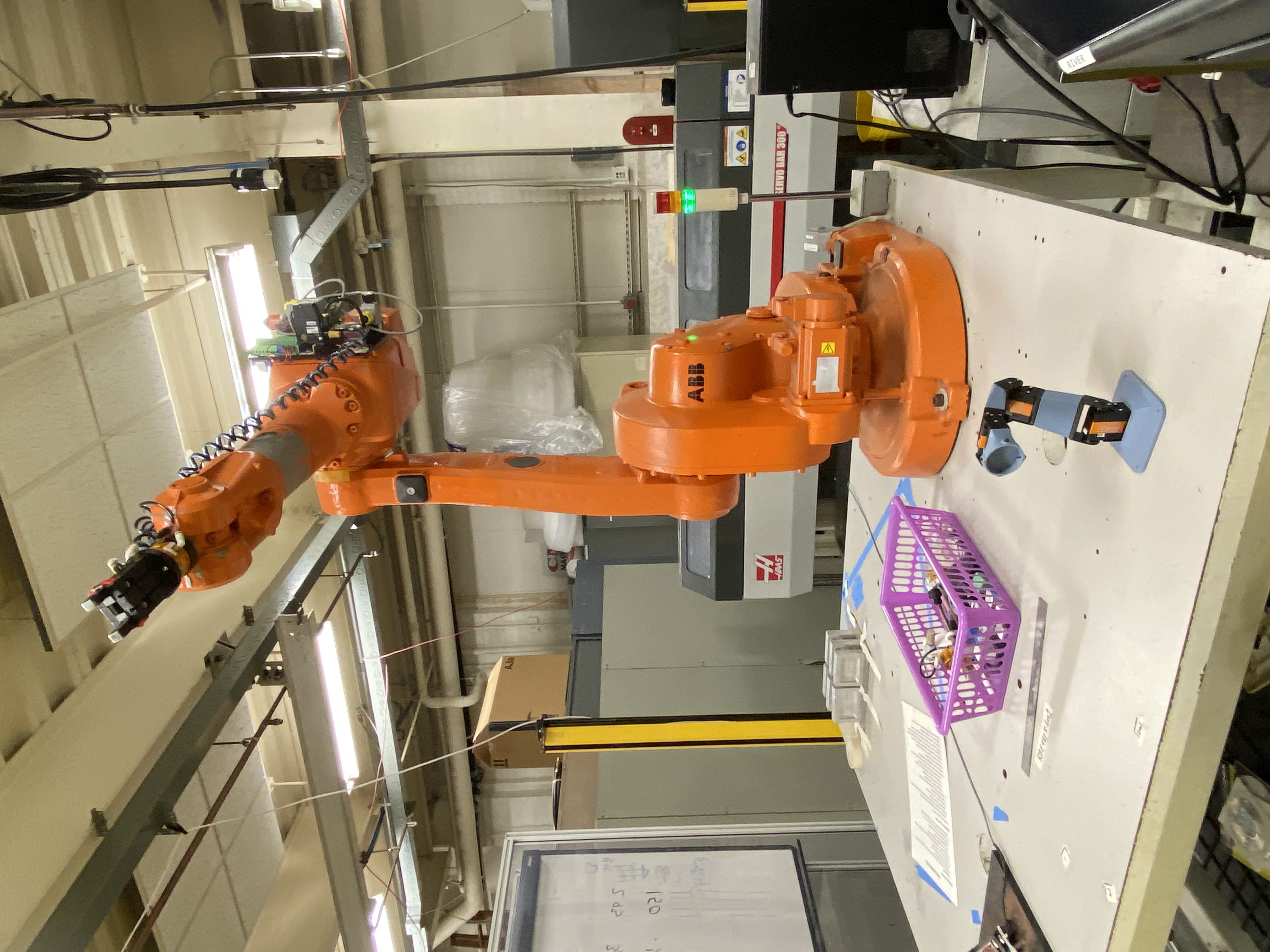 Industrial robot arm compared to our small robot arm